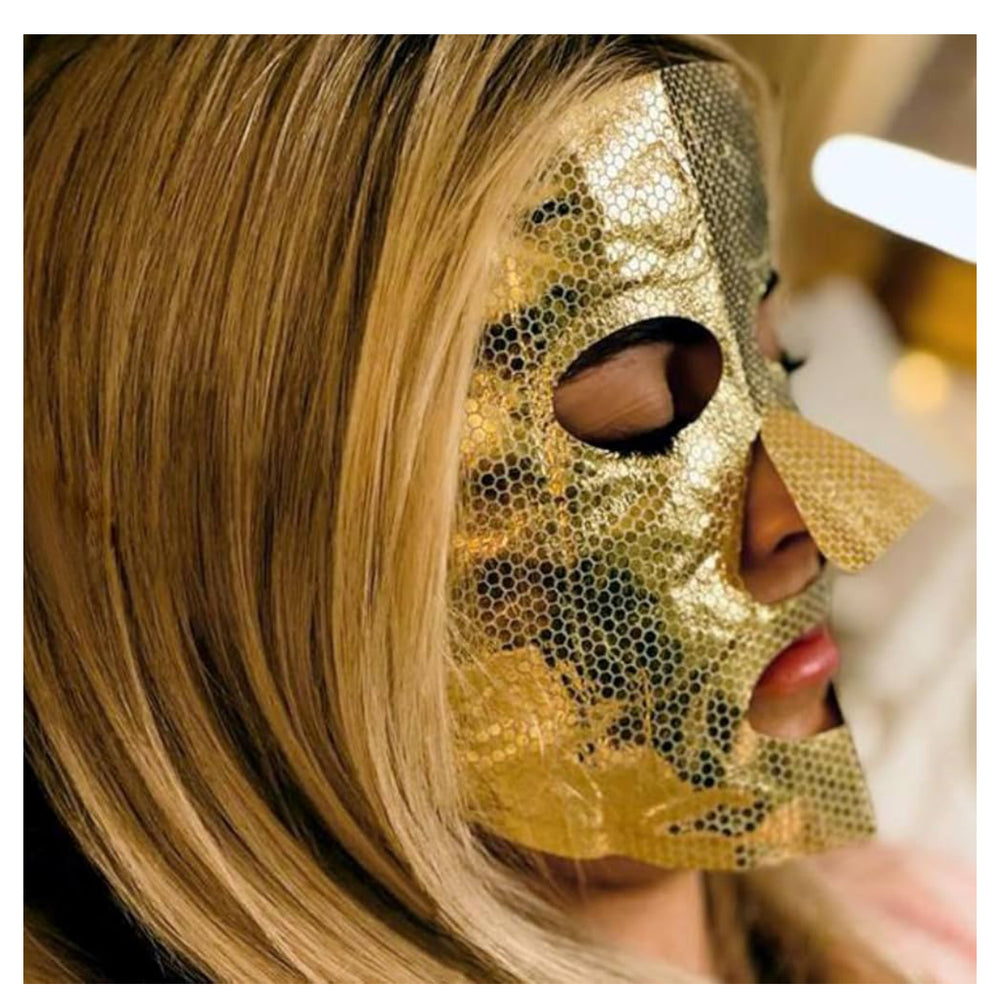 Close-up of a woman wearing a gold Popmask Glow Getter steam mask