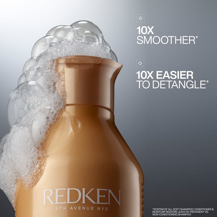Redken All Soft Shampoo bottle surrounded by rich lather