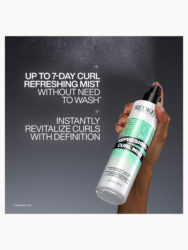 Hand spraying Redken Refreshing Curl Mist: refreshes curls for up to 7 days